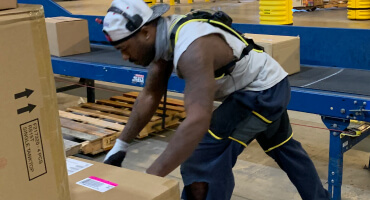 Man lifting boxes in suit